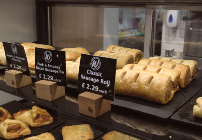 Warm rolls and sandwiches displayed in a Fri-Jado hot food display