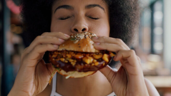 Woman enjoying eating a hamburger